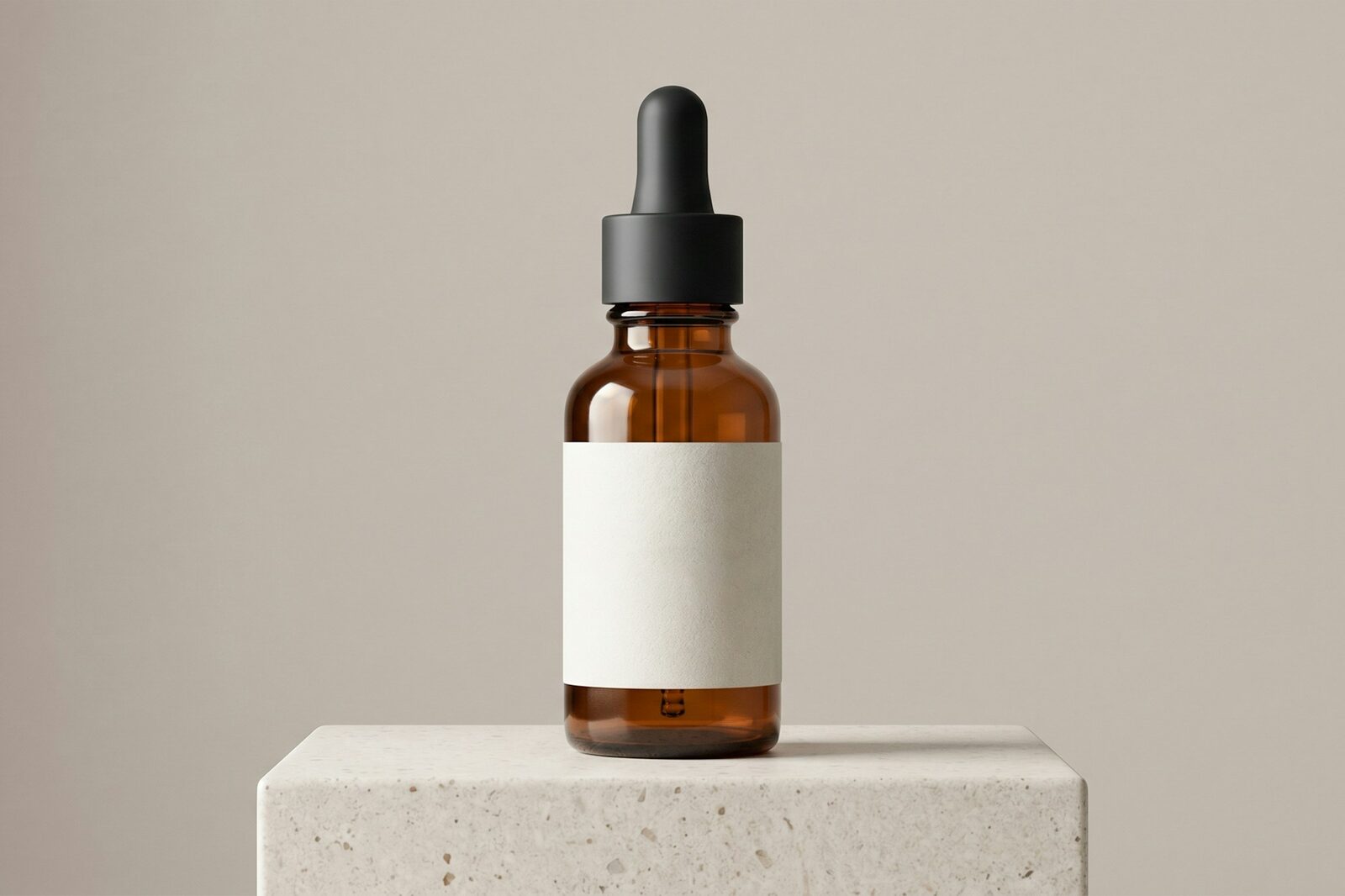 Amber glass dropper bottle on a concrete block
