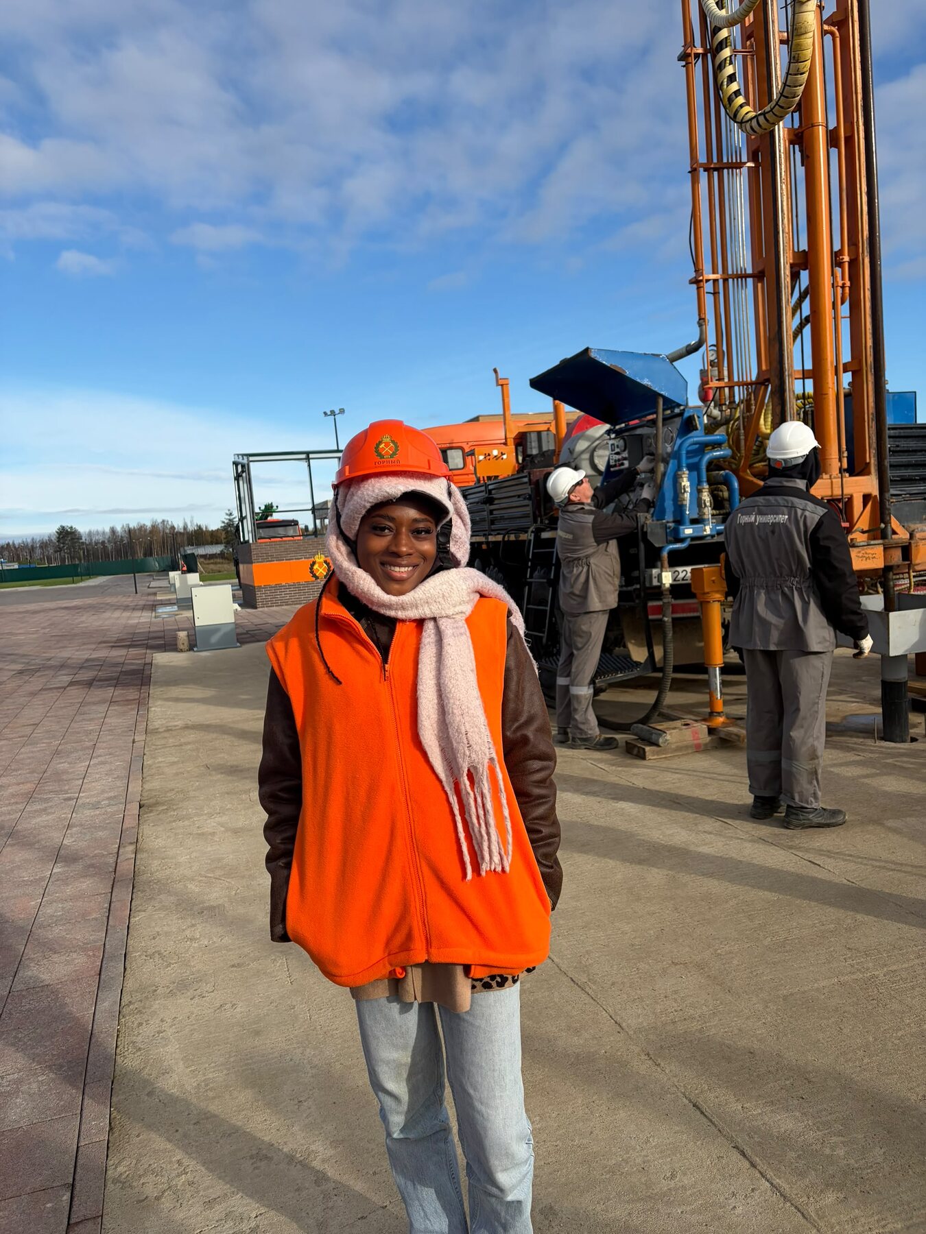 Tracy on an industrial site in a hard hat and high-visibility vest