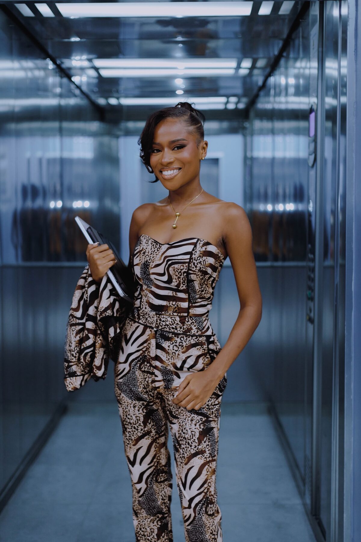 Tracy Tenkorang smiling, holding a laptop